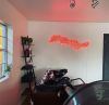 Lather Rinse Repeat red neon light wall mounted in hair salon @roots_beautybar made by Custom Neon