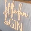 Let the Fun beGIN large neon sign - shown attached to the front of a gin bar at an event - photo from CustomNeon.com