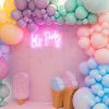 Let's Party portable LED neon sign shown on the photo wall of a kids party - photo from CustomNeon.com