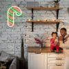 Light Up Candy Cane on white brick wall with Christmas lights & decorations - CUSTOM NEON®