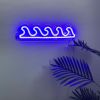 Ocean Waves Custom Neon® Sign shown in dark blue wall mounted in a living room