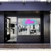 Pink open sign with a blue rectangular shown lit up on the window of a beauty salon - photo CustomNeon.com