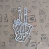 Skeleton hand peace sign in LED neon flex by Custom Neon® shown turned off.