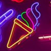 Custom Neon® Soft Serve Ice Cream Light Sign shown illuminated against a dark background in dim light 