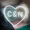 Personalized Heart Neon Sign in LED Flex with clear acrylic background, shown on a pillow - from Custom Neon®