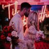 Til Death LED neon sign shown behind the happy couple at a wedding - photo from CustomNeon.com @customneon