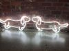 Cute Weiner Dog neon art shown against an exposed brick wall - photo from CustomNeon.com