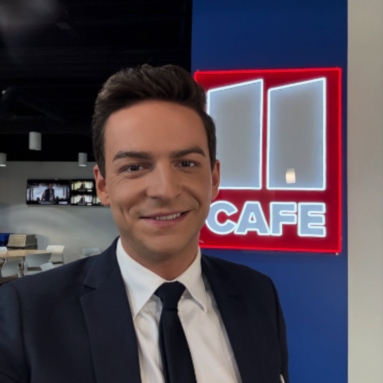 11Alive reporter Moritz Neuss  in front of the red and white 11 Cafe LED neon sign at the station's Atlanta studio