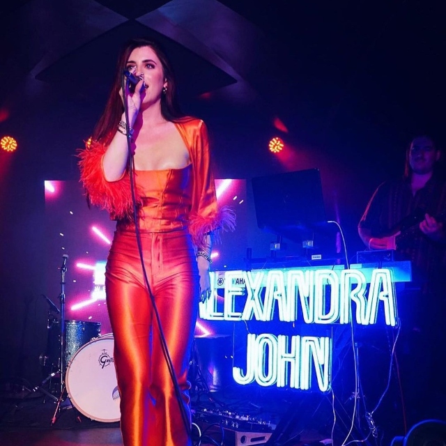 Deep blue Alexandra John Custom Neon® stage sign @alexandrajohnmusic