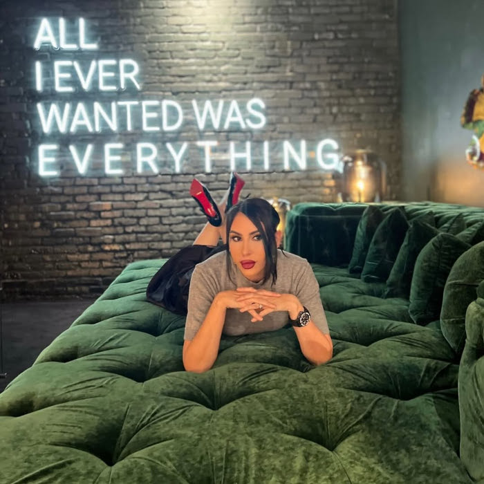 All I ever wanted was everything white Custom Neon® quote sign on a dark brick wall in a living room designed by @morroneinteriors