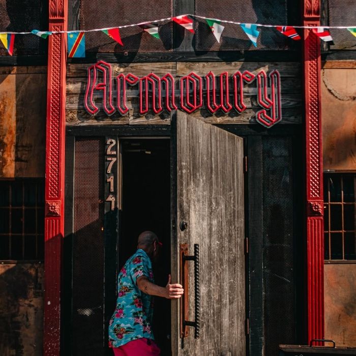 Daytime view of the Armoury custom neon sign over the doorway of the Deep Ellum bar in Dallas