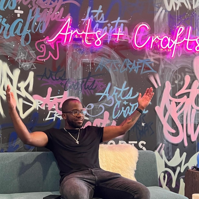 Deep pink Custom Neon® sign reading arts + crafts on grafitti wall @artsandcraftsholdings