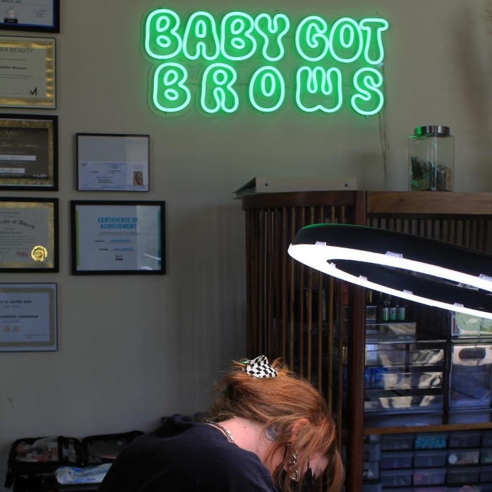 Green Custom Neon® brow salon logo sign @babygotbrows