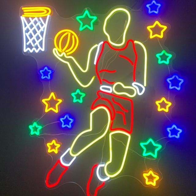 Custom Neon® artwork of a basketball player dunking the ball on a dark wall in the Las Vegas Feature store