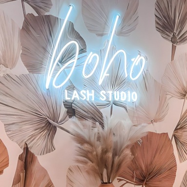 Custom Neon® white salon name sign on a wallpapered wall @boholash.esthetics
