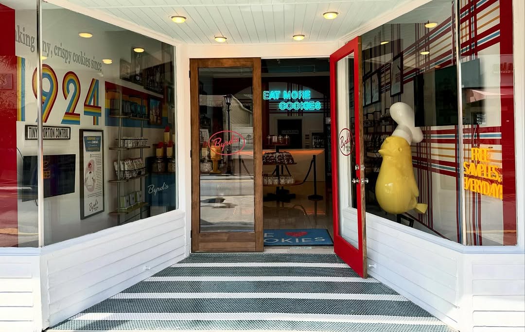 Custom Neon® blue Eat More Cookies sign in a Byrd Cookie Co store