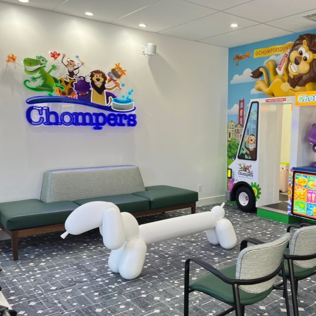 Chompers colorful logo sign on a white wall at the Chompers Dental clinic