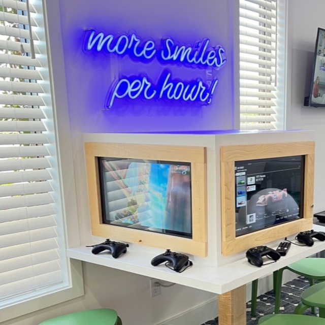 More smiles per hour dark blue LED Custom Neon® dentist quote sign in the games room @chompersdental