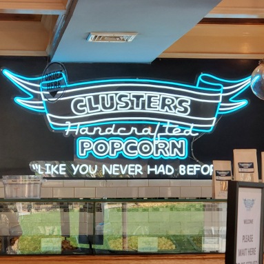 Custom Neon® green light up sign on the evideon.com banner at the @himss23 exhibition