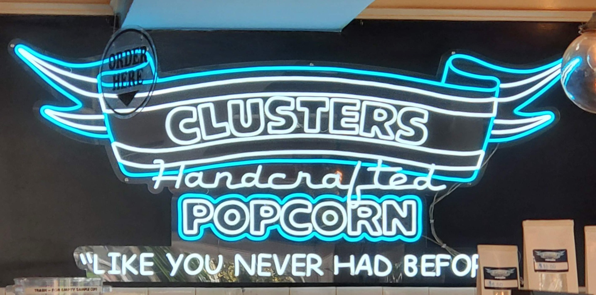 Custom Neon® white and blue neon Clusters handcrafted popcorn logo sign @clusterspopcorn