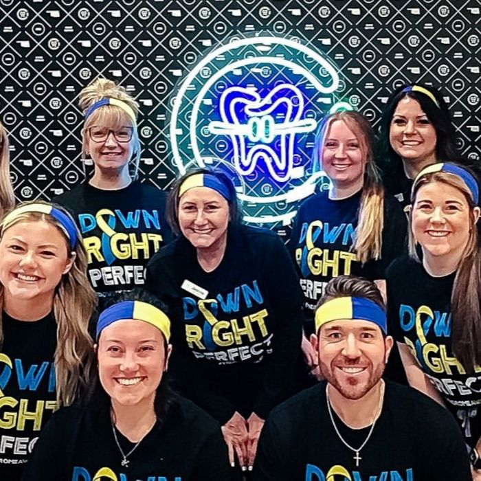  Custom Neon® white and blue icon of a tooth inside a C on a branded selfie wall @coreorthodontics dental clinic