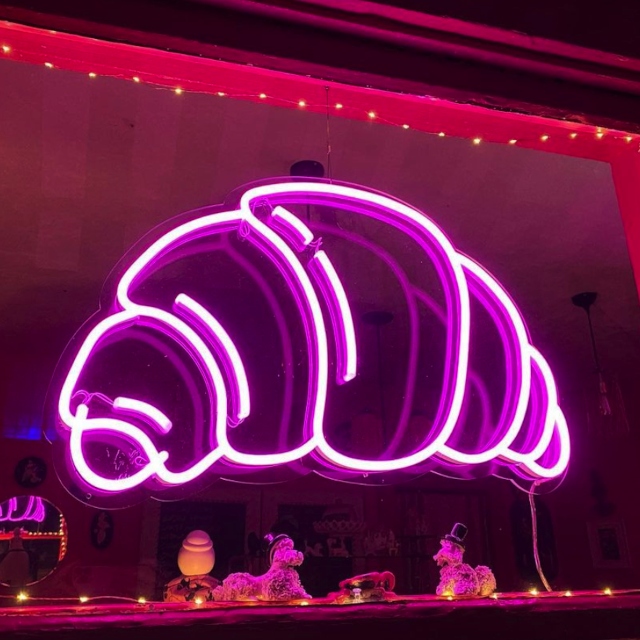 Large pink croissant Custom Neon® art in the storefront window @patisseriejacqui