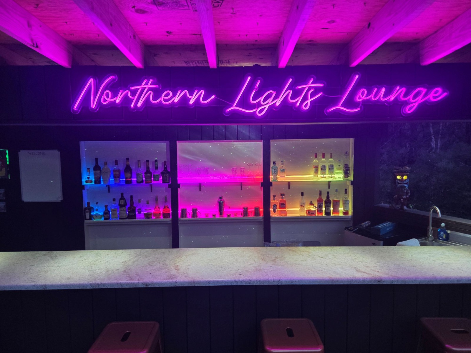 Northern Lights Lounge Custom Neon® color changing outdoor bar sign set to pink