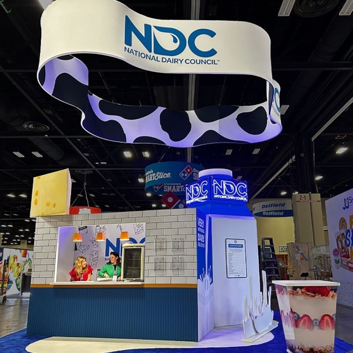 Custom LED neon sign for the National Dairy Council above a trade show booth in Chicago