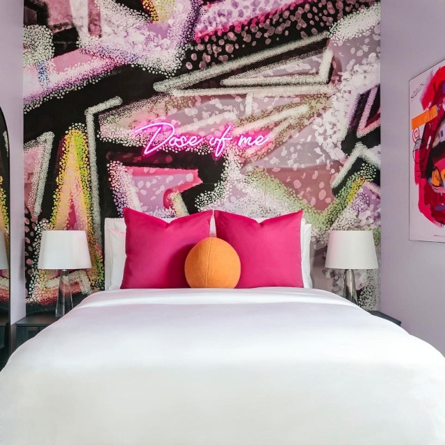 Does of me pink Custom Neon® sign on an interior designed mural wall above a bed @somerled.designs