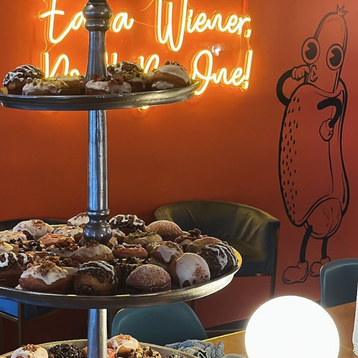 Yellow eat a weiner don't be one! Custom Neon® selfie wall sign @shortleashhotdogs