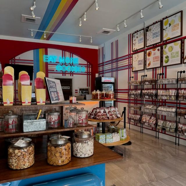 Custom Neon® blue Eat More Cookies sign in a Byrd Cookie Co store