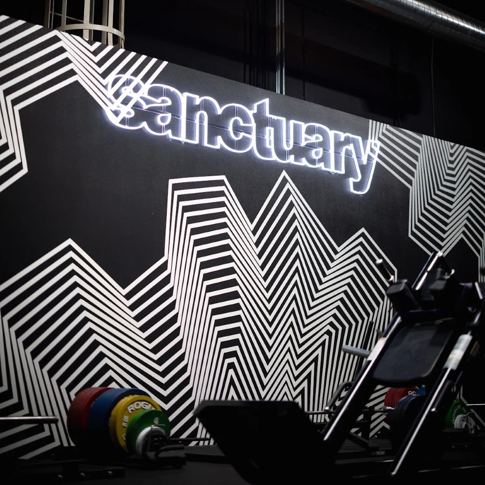 Large white Sanctuary sign in double lined LED neon flex on a black and white backdrop @fallensanctuarygym