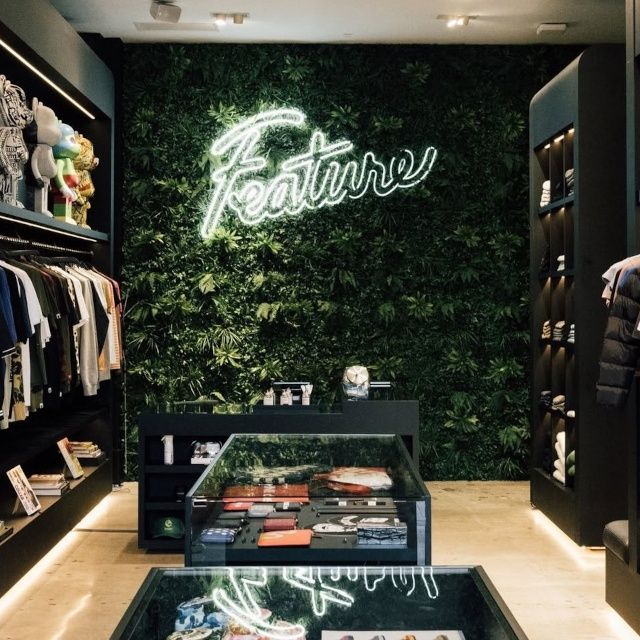 Inside of the Feature store in Las Vegas with a white Custom Neon® Feauture logo sign, clothing, shoes and other merchandise