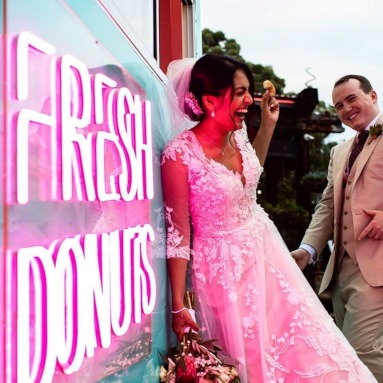 Custom Neon® pink fresh donuts sign on the outside of the duck egg blue van @holydoughco catering for a wedding - photo by @sophiegrangerphotography