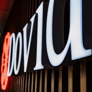 Custom Neon® front lit stainless steel Dovida logo illuminated by white LED lights