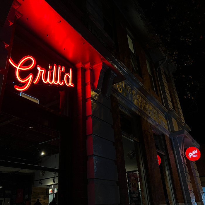 Custom Neon® Grill'd sign above the restaurant entrance