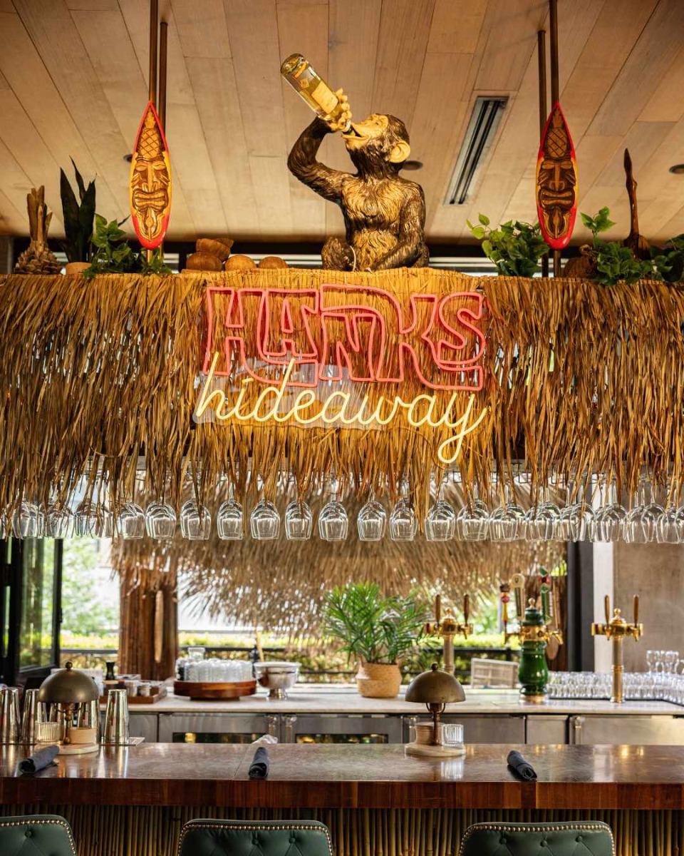 Hanks Hideaway red and warm white Custom Neon® hung from the top of the bar at the Henry Rooftop in Dallas