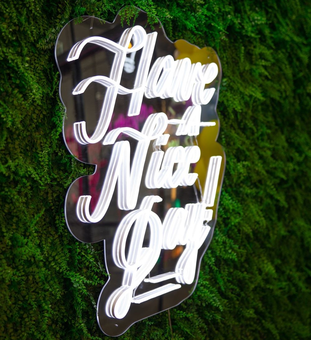 Green wall with Custom Neon® Have a Nice Day sign 