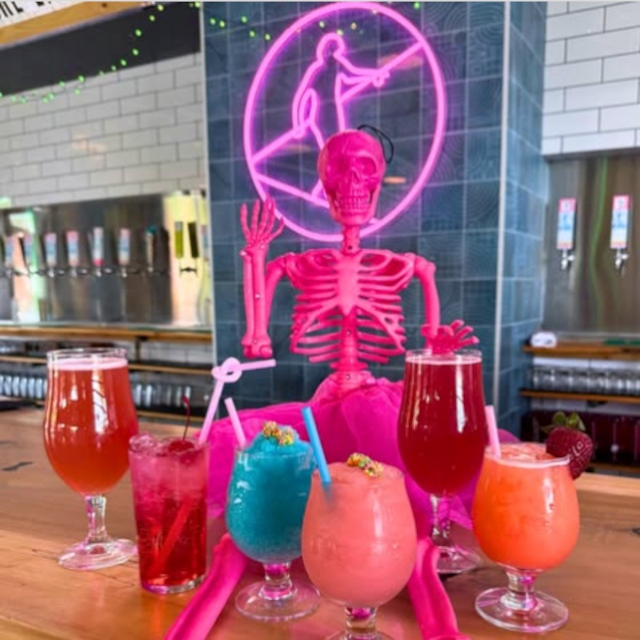 Custom Neon® pink @hiwirebrewing logo behind the bar @hiwirebrewing_clt