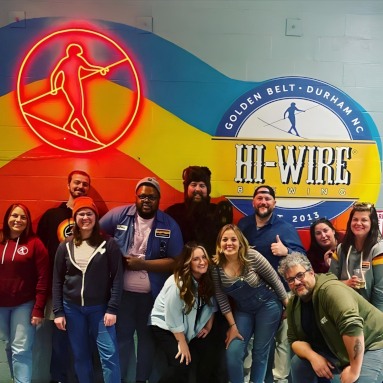 @hiwirebrewing logo sign in red LED neon by Custom Neon® on a large mural selfie wall @hiwirebrewing_durm