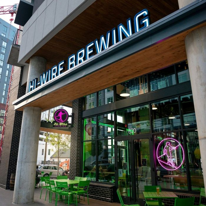 Hi-Wire Brewing Nashville taphouse with a pink logo in the window made by Custom Neon® shown from outside the venue @hiwirebrewing_nash