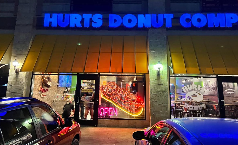 Multicolored window art bakery sign by Custom Neon® @hurtsdonutcompany