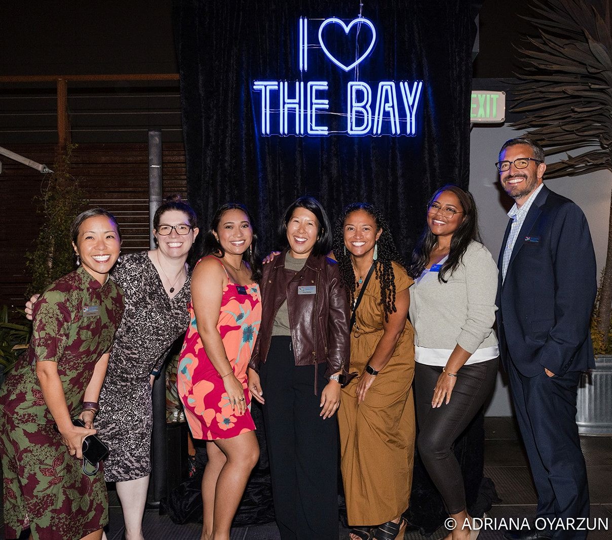 I Love the Bay blue double lined Custom Neon® selfie sign as the backdrop for an event hosted by the San Francisco Foundation