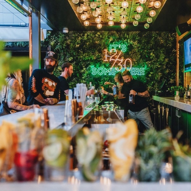 Custom Neon® restaurant quote sign on a grass wall @thetwelvethirtyclub