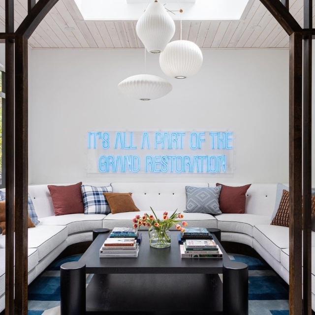 Ice blue It's All a Part of the Grand Restoration LED neon sign in a bright Atlanta lounge room