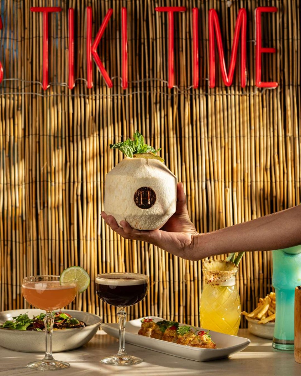 It's Always Tiki Time red Custom Neon® sign hung on the wall at the Henry Rooftop Bar in Dallas