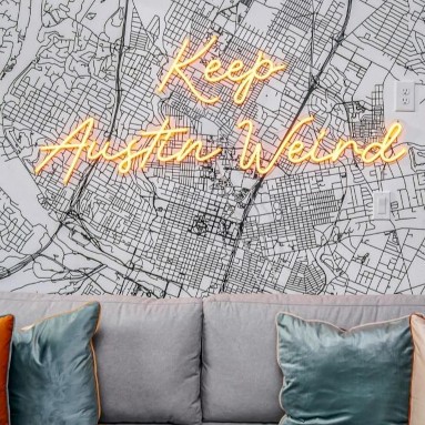 Keep Austin Weird orange LED Custom Neon® sign on a large wall map of the city in an Airbnb home designed by Somerled