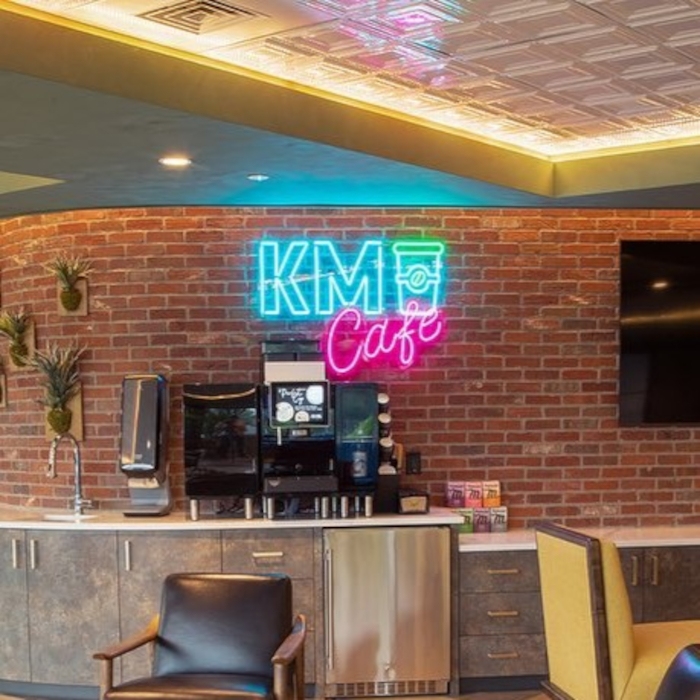 Custom Neon® cafe logo sign on brick wall @skoposdesignco