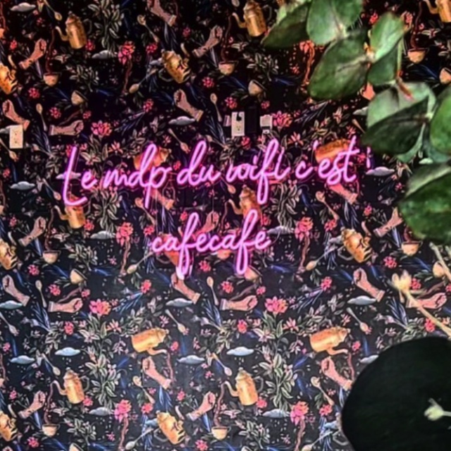 Pink Custom Neon® French cafe sign on fetaure wall @armelle.cafe