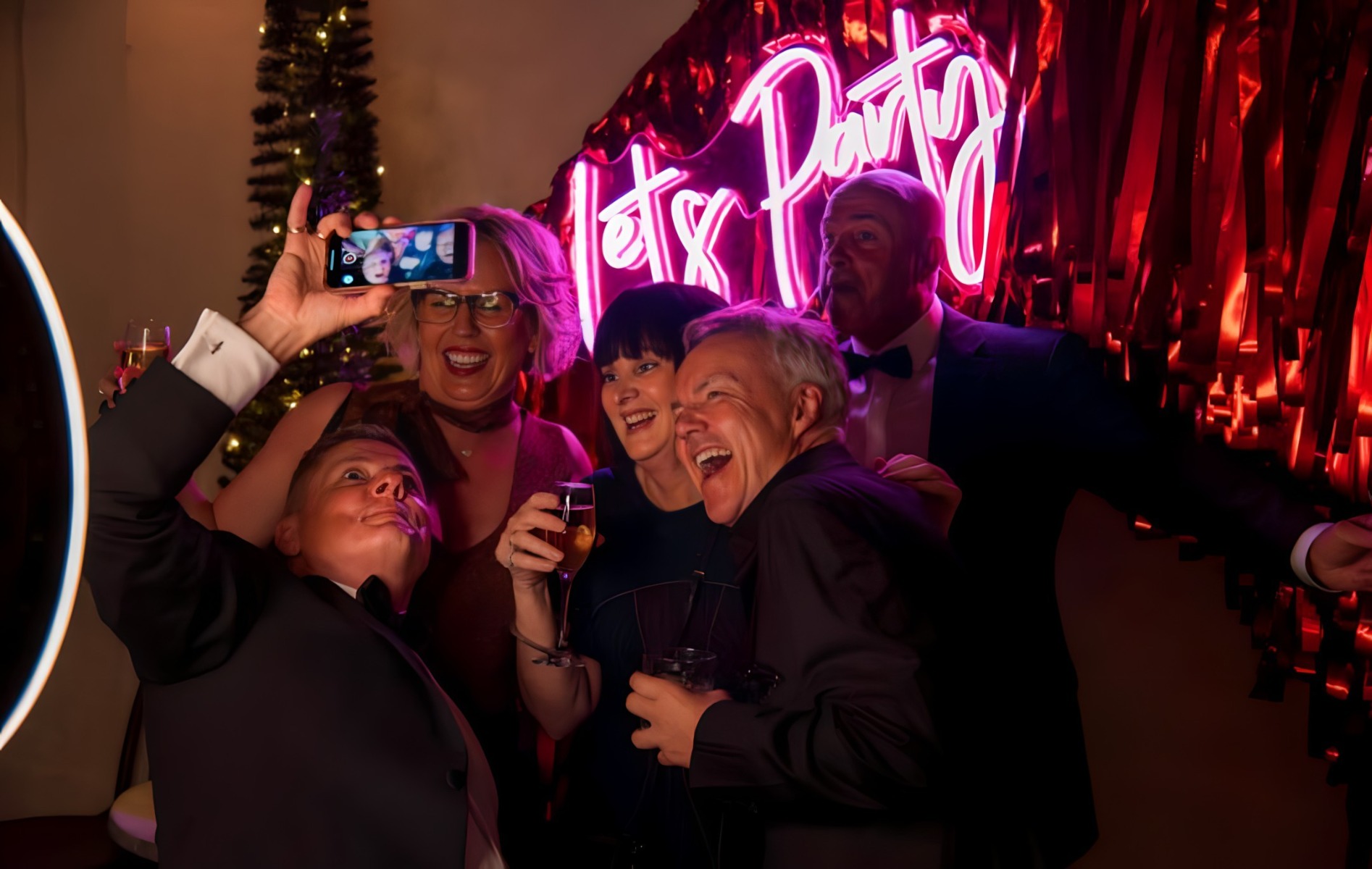 Let's Party pink Custom Neon® light backdrop on a streamer wall @thewarehouse